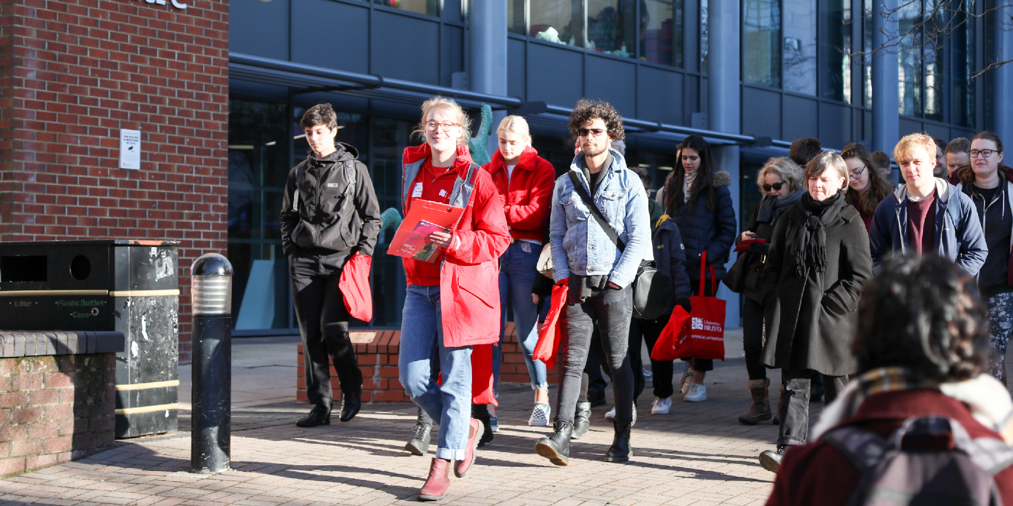 A student ambassador leading a group of people on a tour of the University of Bristol campus